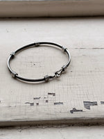 black lined silver hook bangle