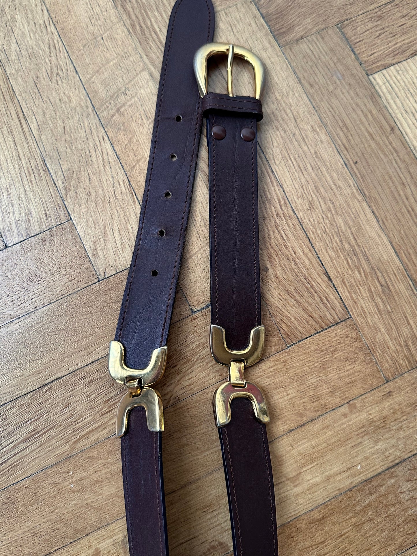 brown leather belt with gold buckle