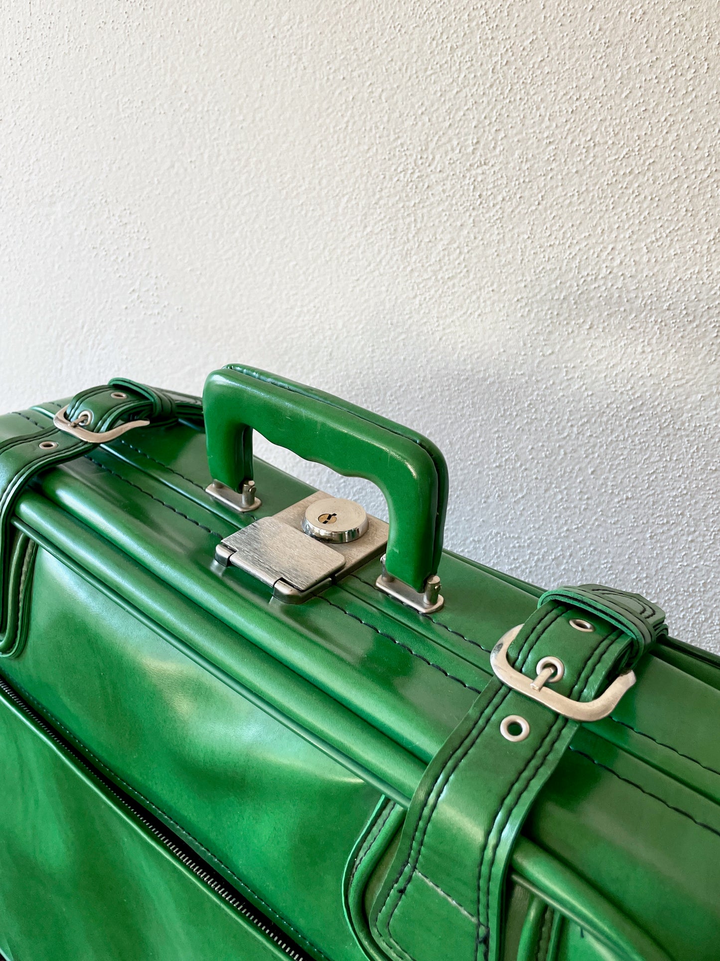 green leather travel bag