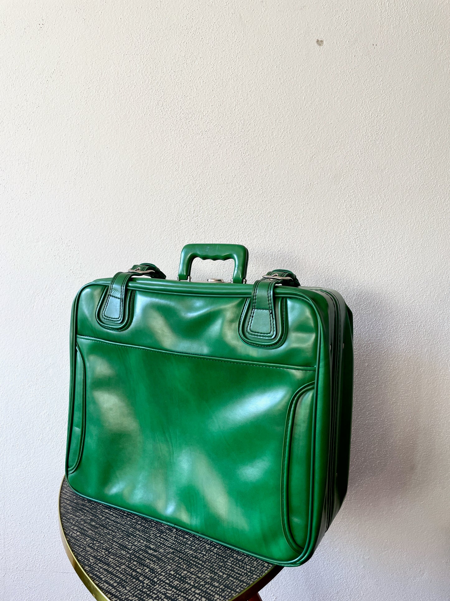 green leather travel bag