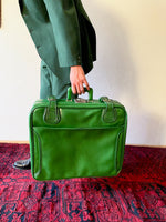 green leather travel bag