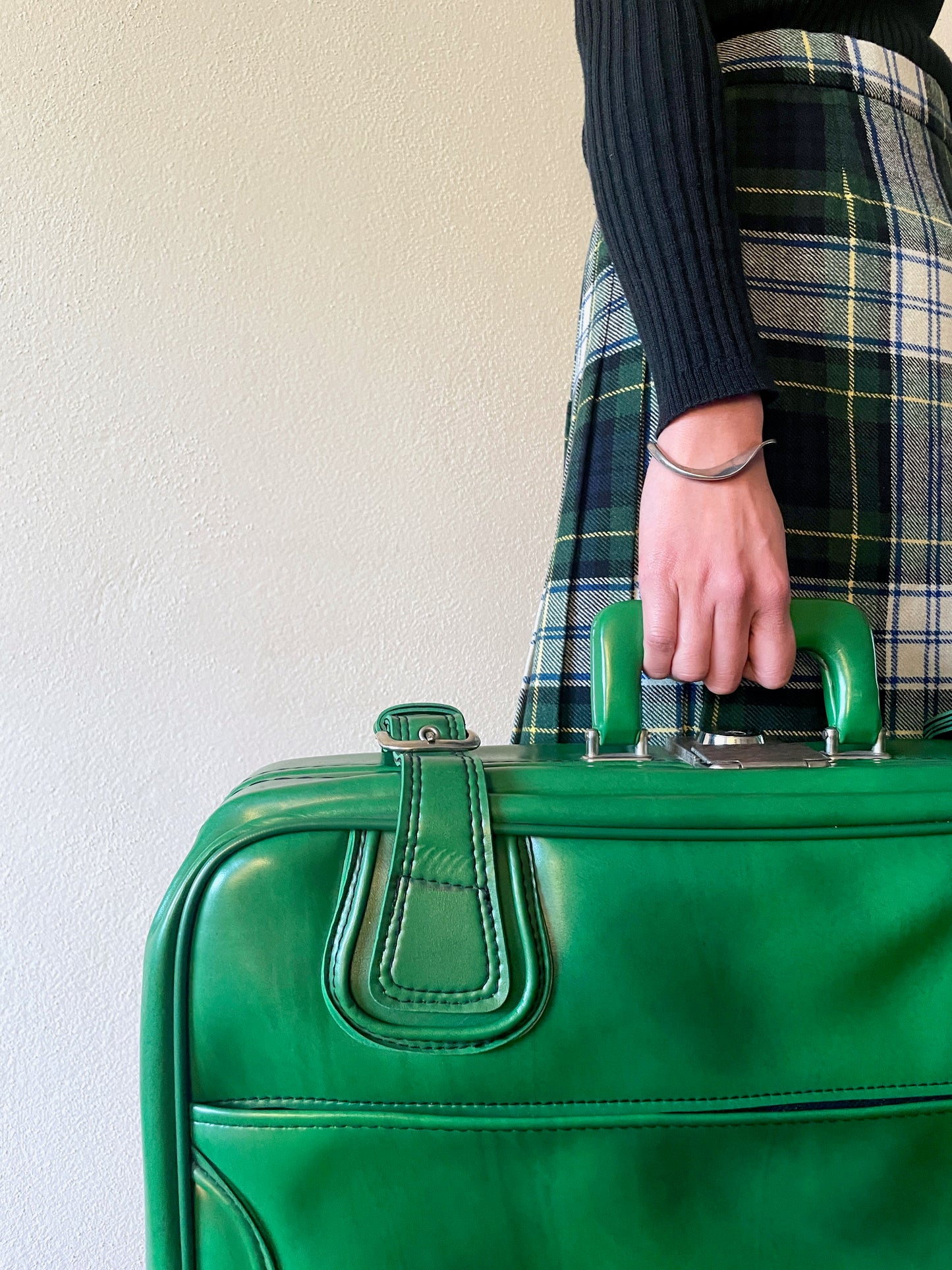 green leather travel bag